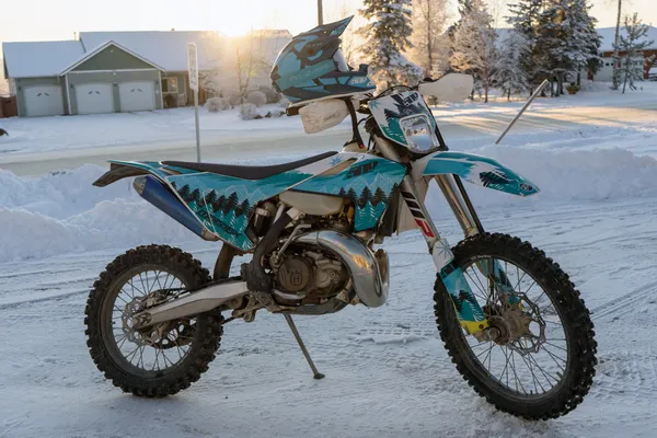 a Husqvarna with a blue, black and teal Absolute Zero Custom Vinyl Wrap